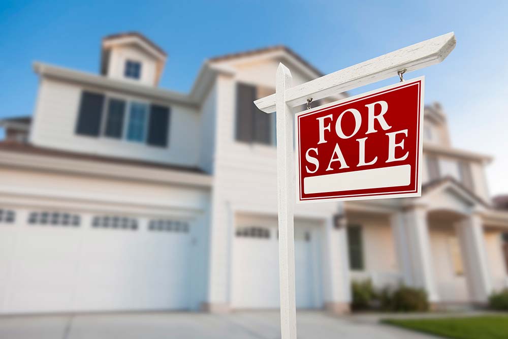 For sale sign in front of a house after receiving thorough home inspection services