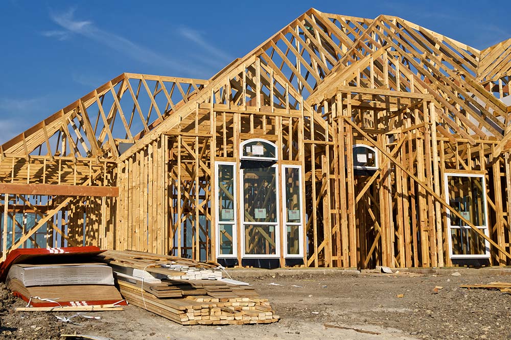 Wood beams of a house being constructed before home inspection services are provided